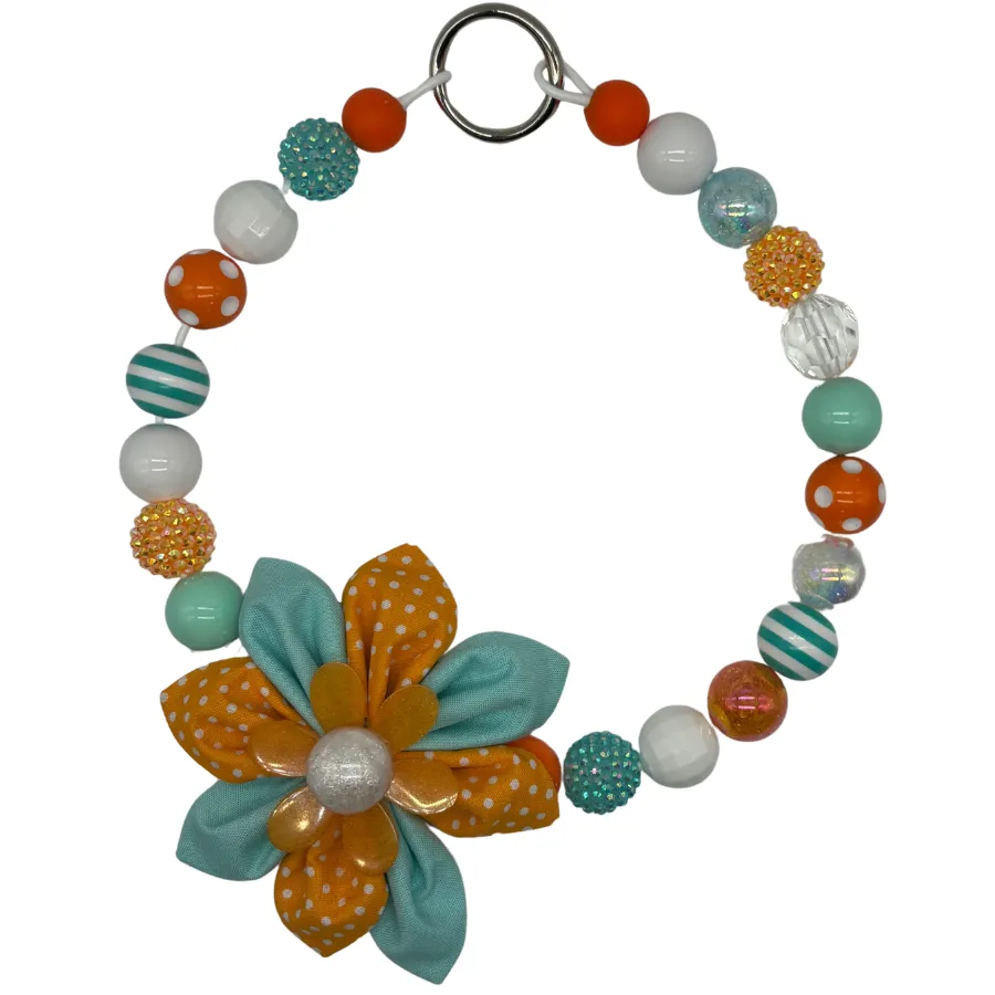 Colorful beaded necklace with fabric flower pendant.