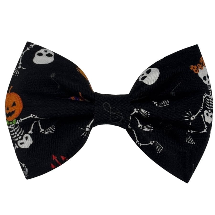Halloween-themed bow tie with skeletons and pumpkins.